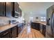A modern kitchen with stainless steel appliances, dark wood cabinetry, and an adjacent dining area at 447 Lanham Dr, Winter Haven, FL 33881