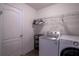 Functional laundry room with a modern washer and dryer set and shelving at 447 Lanham Dr, Winter Haven, FL 33881