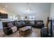 Spacious living room featuring a large leather sectional, wood-look flooring, and a modern ceiling fan at 447 Lanham Dr, Winter Haven, FL 33881
