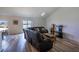 Bright living room boasts wood-look floors, a comfy leather sofa, and ample natural light at 447 Lanham Dr, Winter Haven, FL 33881