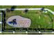 Aerial view of community playground with swings, slide, benches, and green space at 447 Lanham Dr, Winter Haven, FL 33881
