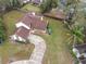 An aerial view of a single-Gathering home showcasing its brown roof, landscaping, driveway, and yard at 4765 Lantern Ct, Orlando, FL 32808