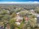 Aerial shot of the property and surrounding neighborhood, with a spacious lot and mature trees at 4765 Lantern Ct, Orlando, FL 32808