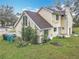 Exterior of the house with back yard, tree coverage, and home's architectural design at 4765 Lantern Ct, Orlando, FL 32808