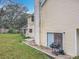 Home's exterior with a view of the chimney, sliding glass doors, and the expansive backyard at 4765 Lantern Ct, Orlando, FL 32808