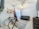 Bright room with a desk, ceiling fan, and a black leather futon providing versatile space at 4765 Lantern Ct, Orlando, FL 32808