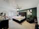 Stylish bedroom featuring a large, tufted headboard, modern art, and a comfortable recliner at 4765 Lantern Ct, Orlando, FL 32808