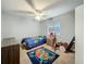 Cozy bedroom with a ceiling fan and a bright window at 4765 Lantern Ct, Orlando, FL 32808