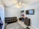 Comfortable bedroom features a loveseat, ceiling fan, and tv at 4765 Lantern Ct, Orlando, FL 32808