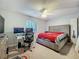 A cozy bedroom features a plush bed, ceiling fan, and a practical desk area at 4765 Lantern Ct, Orlando, FL 32808
