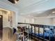 Elevated dining area with a glass table, modern chairs, and open view of the living room at 4765 Lantern Ct, Orlando, FL 32808