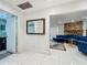 Bright foyer with white tile floors leading to a stylish living room with fireplace at 4765 Lantern Ct, Orlando, FL 32808