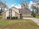 Charming two-story home featuring a unique window and a brick and siding facade at 4765 Lantern Ct, Orlando, FL 32808