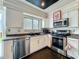 Close-up of modern kitchen, including stainless steel appliances, dishwasher, and undermount sink at 4765 Lantern Ct, Orlando, FL 32808