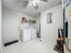 Laundry room with white washer and dryer, utility sink, and a door to the exterior at 4765 Lantern Ct, Orlando, FL 32808