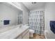 Traditional bathroom with a vanity, a framed mirror, and a shower featuring a patterned shower curtain at 5115 Woodgreen Ln, Lakeland, FL 33811