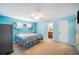 Bright blue bedroom boasts a ceiling fan and ensuite bathroom, offering style and convenience at 5115 Woodgreen Ln, Lakeland, FL 33811