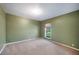 This neutral bedroom offers ample space and natural light from the window at 5115 Woodgreen Ln, Lakeland, FL 33811