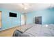 Spacious bedroom painted a cheerful blue, complete with a ceiling fan and a wall-mounted television at 5115 Woodgreen Ln, Lakeland, FL 33811
