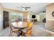 This dining room is complete with neutral walls, plush carpeting, and a classic ceiling fan at 5115 Woodgreen Ln, Lakeland, FL 33811