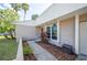 A cozy front entrance with a tiled walkway and manicured landscaping, creating a welcoming first impression at 5115 Woodgreen Ln, Lakeland, FL 33811