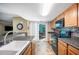 Bright kitchen featuring wood cabinets, tile backsplash, modern appliances, sink, and sliding door to outdoor patio at 5115 Woodgreen Ln, Lakeland, FL 33811