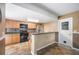 The kitchen features wooden cabinets, stainless steel appliances, and a breakfast bar with patterned tile flooring at 5115 Woodgreen Ln, Lakeland, FL 33811