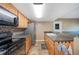 This kitchen features sleek countertops, wood cabinets, stainless steel appliances, and tiled backsplash at 5115 Woodgreen Ln, Lakeland, FL 33811