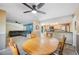 Bright and spacious open-concept living space with carpeting, neutral walls, and dining area with wooden table at 5115 Woodgreen Ln, Lakeland, FL 33811