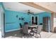 A screened-in patio with a round table and six chairs sits outside this beautiful home at 5115 Woodgreen Ln, Lakeland, FL 33811