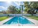 A backyard rectangular in-ground pool with lounge chairs and privacy fence at 5115 Woodgreen Ln, Lakeland, FL 33811