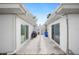 A concrete patio separates two sides of the home's exterior in the grassy backyard at 513 Kelsey St # 513, Lakeland, FL 33803