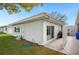 The backyard includes a grassy area, white home exterior, and a concrete patio at 513 Kelsey St # 513, Lakeland, FL 33803