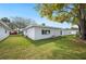 Backyard with grassy area, featuring a view of the home's exterior and a large shade tree at 513 Kelsey St # 513, Lakeland, FL 33803