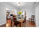 Charming dining room with wood floors, a table set for dinner, connecting to the living room and kitchen at 513 Kelsey St # 513, Lakeland, FL 33803
