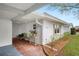 View of the covered walkway with seating leading to the front door at 513 Kelsey St # 513, Lakeland, FL 33803