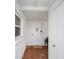 Well-lit entryway with brick flooring and a modern white front door at 513 Kelsey St # 513, Lakeland, FL 33803