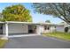 Exterior view of the home showing the carport and tidy front lawn at 513 Kelsey St # 513, Lakeland, FL 33803