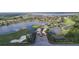Aerial view featuring water features, landscaping and access to the golf course at 5268 Pebble Beach Blvd, Winter Haven, FL 33884