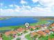 Aerial view showing the property's neighborhood, lake views and golf course location at 5268 Pebble Beach Blvd, Winter Haven, FL 33884