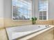 Bright bathroom features a large soaking tub, and tiled surround at 5268 Pebble Beach Blvd, Winter Haven, FL 33884