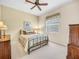 Comfortable bedroom with ceiling fan, carpet, and a large window at 5268 Pebble Beach Blvd, Winter Haven, FL 33884