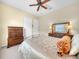 Cozy bedroom with ceiling fan, carpet, and a large window at 5268 Pebble Beach Blvd, Winter Haven, FL 33884