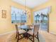 Dining area with a view of the lake and outdoor living space at 5268 Pebble Beach Blvd, Winter Haven, FL 33884