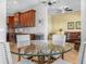 Dining area with a glass table and a view into the living room at 5268 Pebble Beach Blvd, Winter Haven, FL 33884