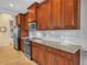 Modern kitchen with stainless steel appliances, granite counters and dark wood cabinets at 5268 Pebble Beach Blvd, Winter Haven, FL 33884