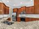 A spacious kitchen with granite countertops, stainless steel appliances and wooden cabinets at 5268 Pebble Beach Blvd, Winter Haven, FL 33884