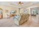 Spacious living room with tan leather couches, tile floors and abundant natural light at 5268 Pebble Beach Blvd, Winter Haven, FL 33884