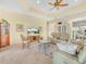 Inviting living room with tile flooring, a tray ceiling, and comfortable seating at 5268 Pebble Beach Blvd, Winter Haven, FL 33884