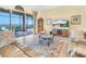 Comfortable living room with tile floors, an entertainment center, and glass sliding doors at 5268 Pebble Beach Blvd, Winter Haven, FL 33884
